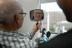 patient smiling brightly after their dental treatment with doctor