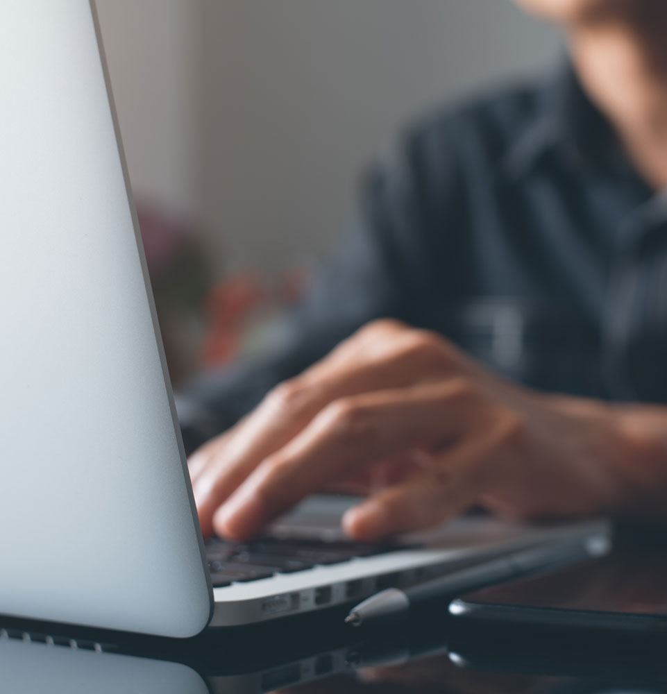 person typing o n their computer