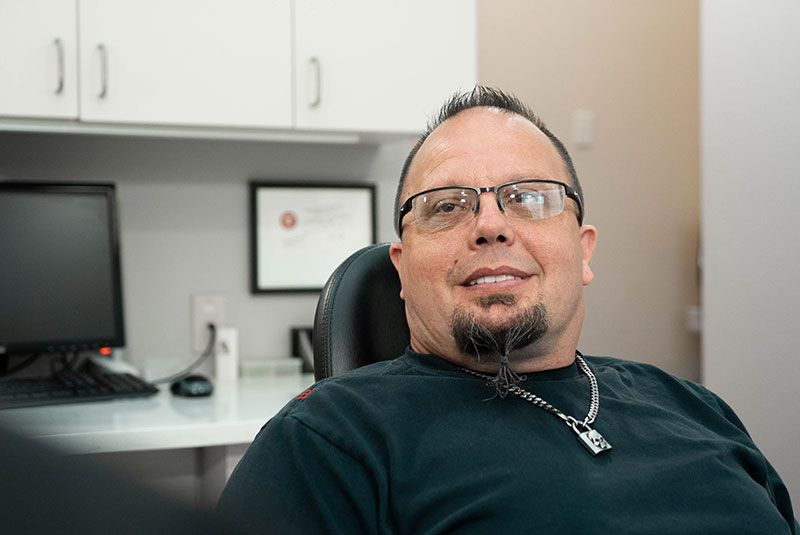 patient smiling while doctor goes over dental treatment info