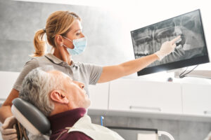 Image showcasing the "steps of a dental implant" as a numbered list. A diverse range of people are in the background smiling, happy with their dental implants. No text on image.