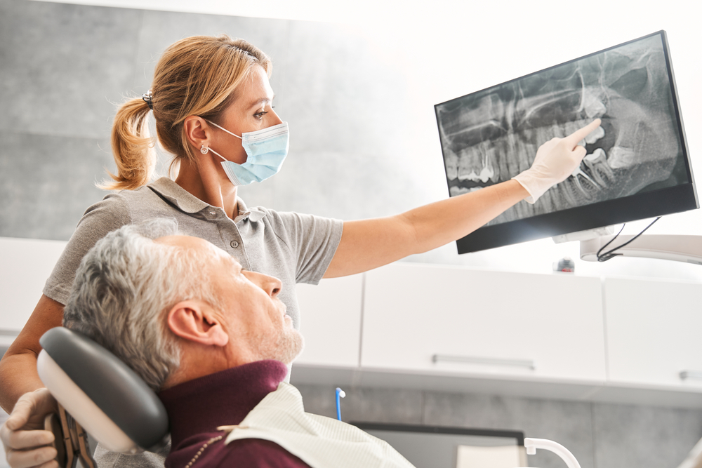 Image showcasing the "steps of a dental implant" as a numbered list. A diverse range of people are in the background smiling, happy with their dental implants. No text on image.
