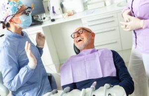 An image of a dentist explaining bone grafting options to a patient using a 3D model of a jawbone with dental implants. The image should convey trust and expertise. No text on the image.